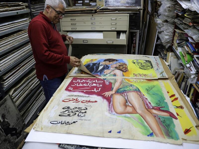 Abboudi Abu Jawdeh shows part of his vintage cinema poster collection at his office in the Lebanese capital Beirut  JOSEPH EID / AFP