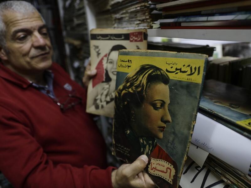 Abboudi Abu Jawdeh shows part of his vintage Lebanese cinema specialised magazines collection at his office in the Lebanese capital Beirut  JOSEPH EID / AFP