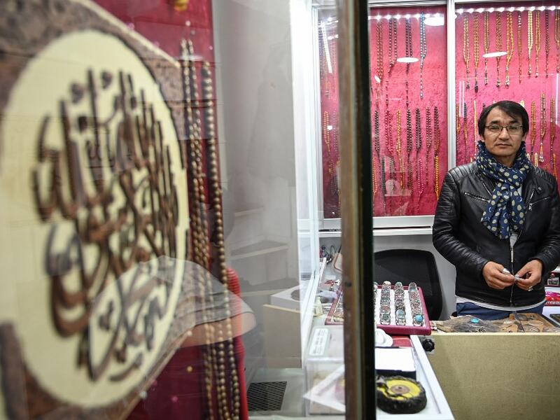 Hadi Ekhlas, engraver, poses for a picture in his workshop at the Grand Bazaar in Istanbul.  OZAN KOSE / AFP