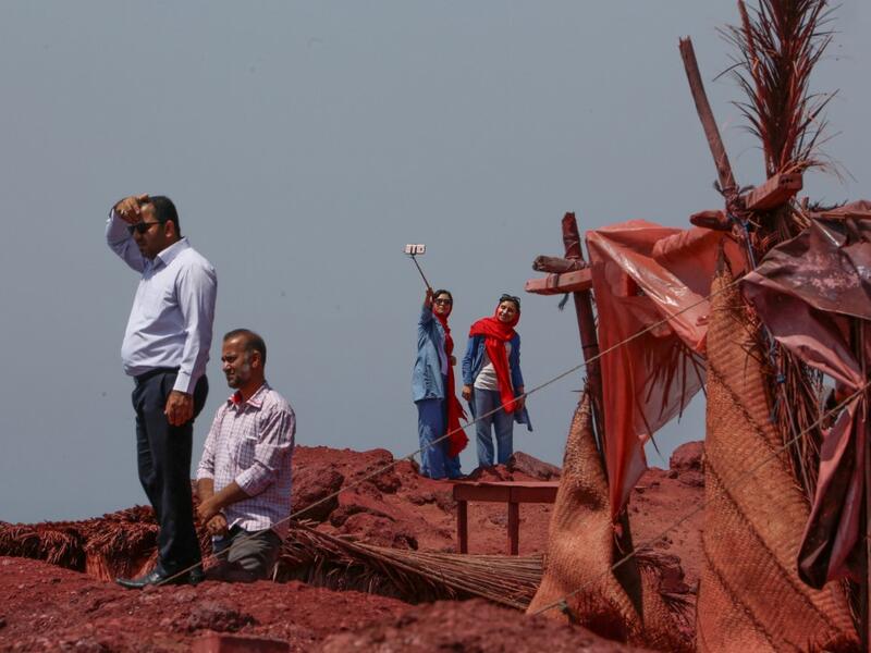 Visitors take a selfie picture on the Hormuz Island in the Gulf Strait of Hormuz, off the Iranian port city of Bandar Abbas, on April 29, 2019.  ATTA KENARE / AFP