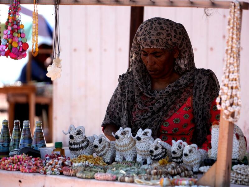 A woman sells souvenirs on the Hormuz Island in the Gulf Strait of Hormuz, off the Iranian port city of Bandar Abbas, on April 29, 2019.  ATTA KENARE / AFP