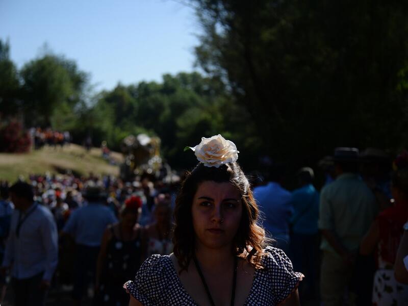 Pilgrims cross the Quema river in Villamanrique, during a pilgrimage to the village of El Rocio.  CRISTINA QUICLER / AFP