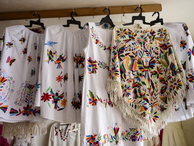 Mexican artisan of the Otomi ethnic group Oliver Teodoro Lopez, shows one of his designs at his workshop in San Nicolas Village, in Tenango de Doria, Hidalgo state, Mexico.  Pedro PARDO / AFP