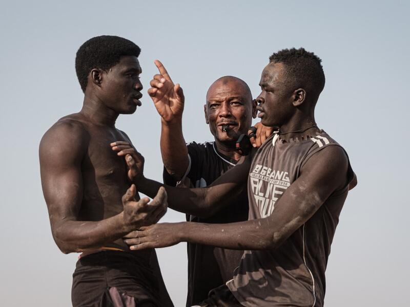 Sudanese wrestlers fight during a traditional Nuba wrestling match at the Haj Youssef stadium in the district of Khartoum.  Yasuyoshi CHIBA / AFP