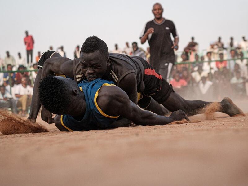 Sudanese wrestlers fight during a traditional Nuba wrestling match at the Haj Youssef stadium in the district of Khartoum.  Yasuyoshi CHIBA / AFP
