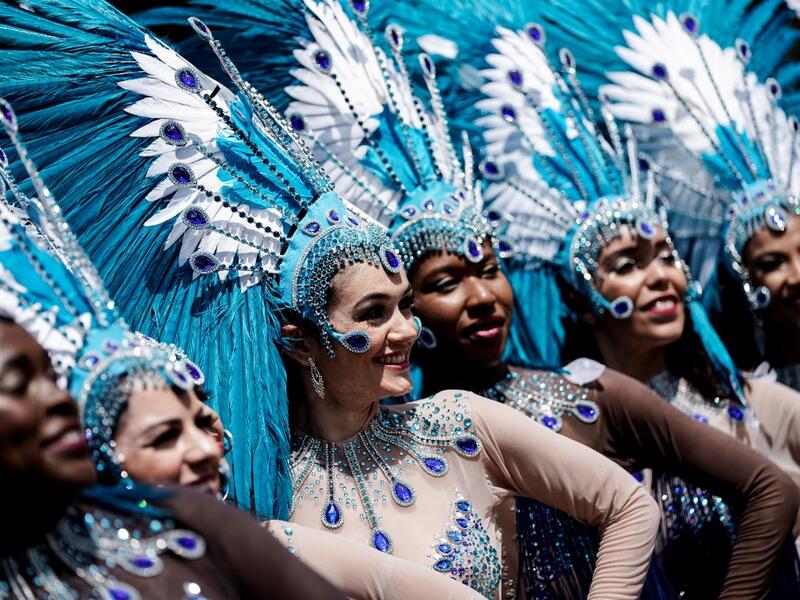People parade during the Tropical Carnival on July, 7 2019 in Paris.  Kenzo TRIBOUILLARD / AFP
