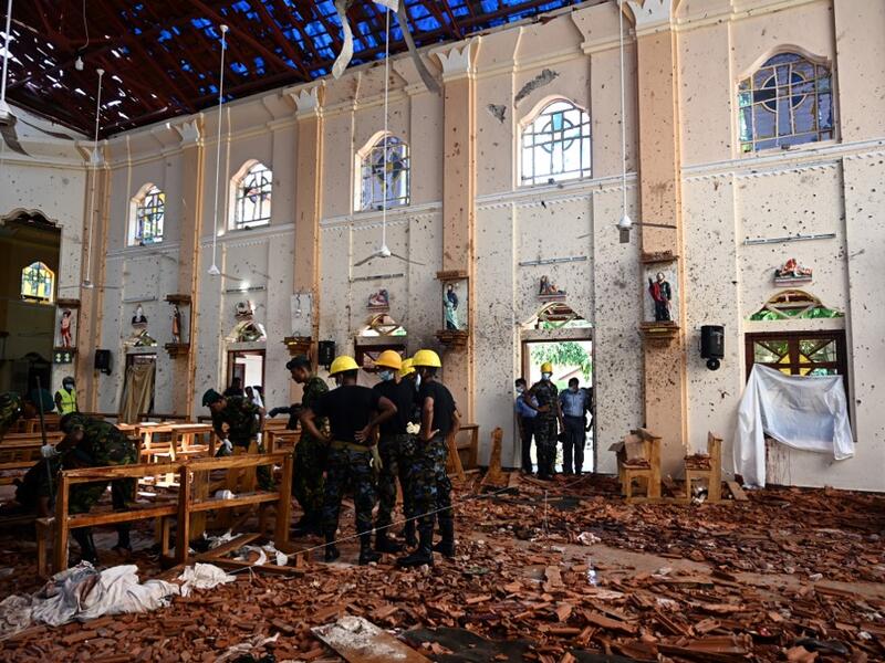 Security personnel inspect the interior of St Sebastian's Church in Negombo on April 22, 2019, a day after the church was hit in series of bomb blasts targeting churches and luxury hotels in Sri Lanka. Jewel SAMAD / AFP