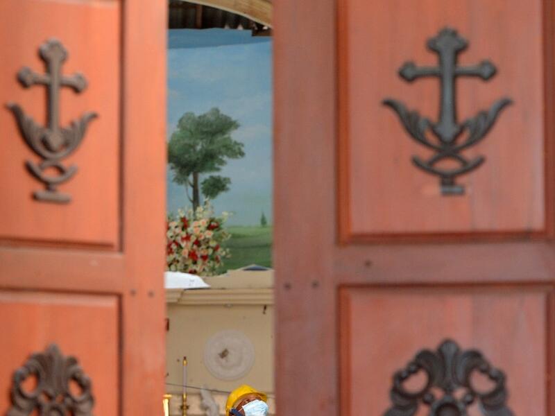 A security personnel inspects the interior of St. Sebastian's Church in Negombo on April 22, 2019, a day after the church was hit in series of bomb blasts targeting churches and luxury hotels in Sri Lanka. ISHARA S. KODIKARA / AFP