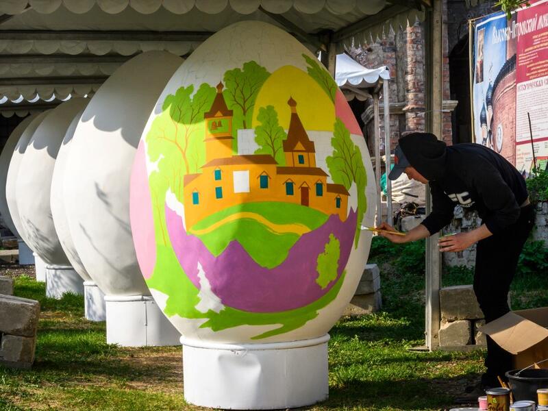 An artist paints a giant Easter egg in the yard of an Orthodox monastery in central Moscow on April 26, 2019, ahead of the Orthodox Easter on April 28, 2019. Russia celebrates the Orthodox Easter on Sunday April 28, 2019. Mladen ANTONOV / AFP
