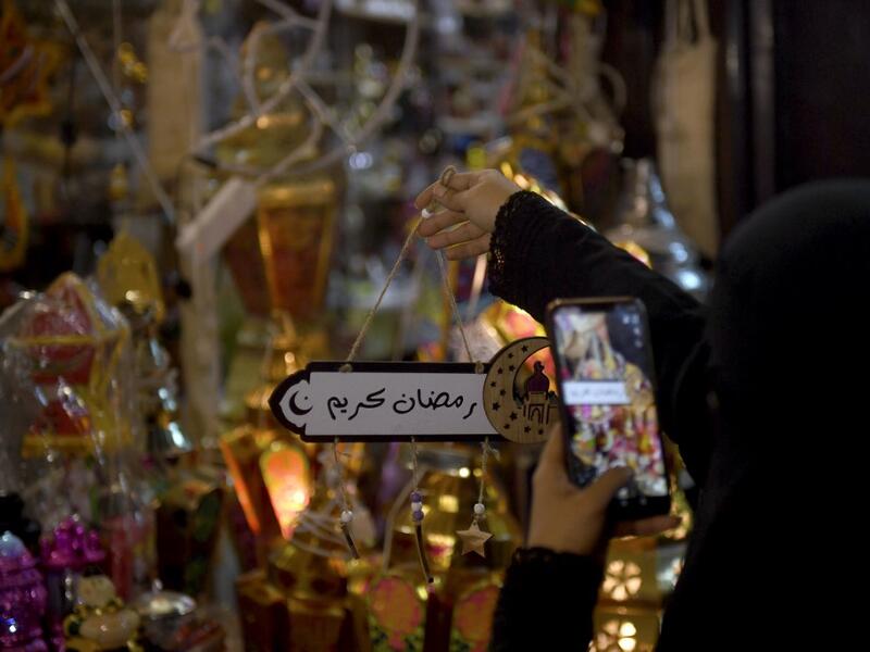 A Saudi woman takes a picture of decorations in the Saudi coastal city of Jeddah on May 3, 2019, ahead of the Muslim holy fasting month of Ramadan.  Amer HILABI / AFP
