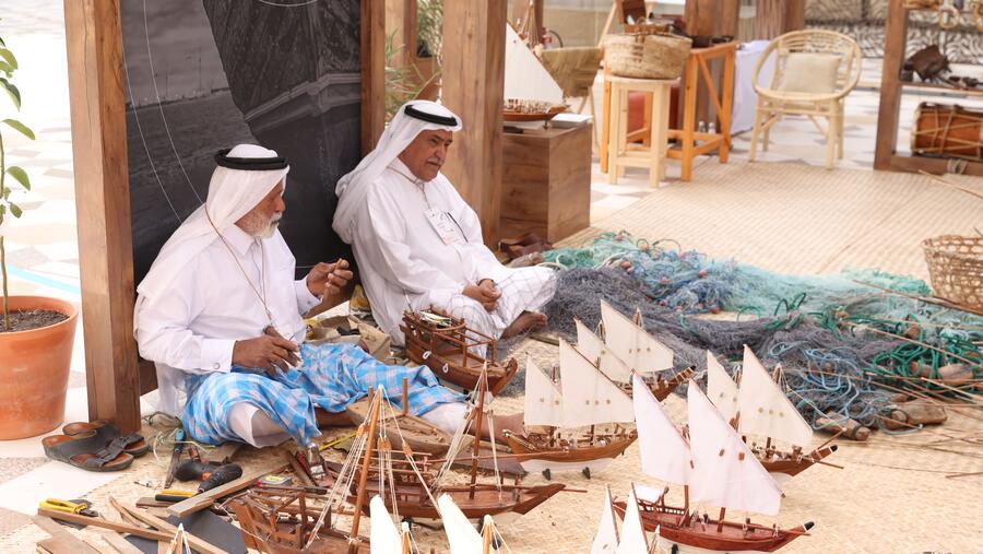 the public interacts with indigenous practices displayed at earthna village at barahat msheireb