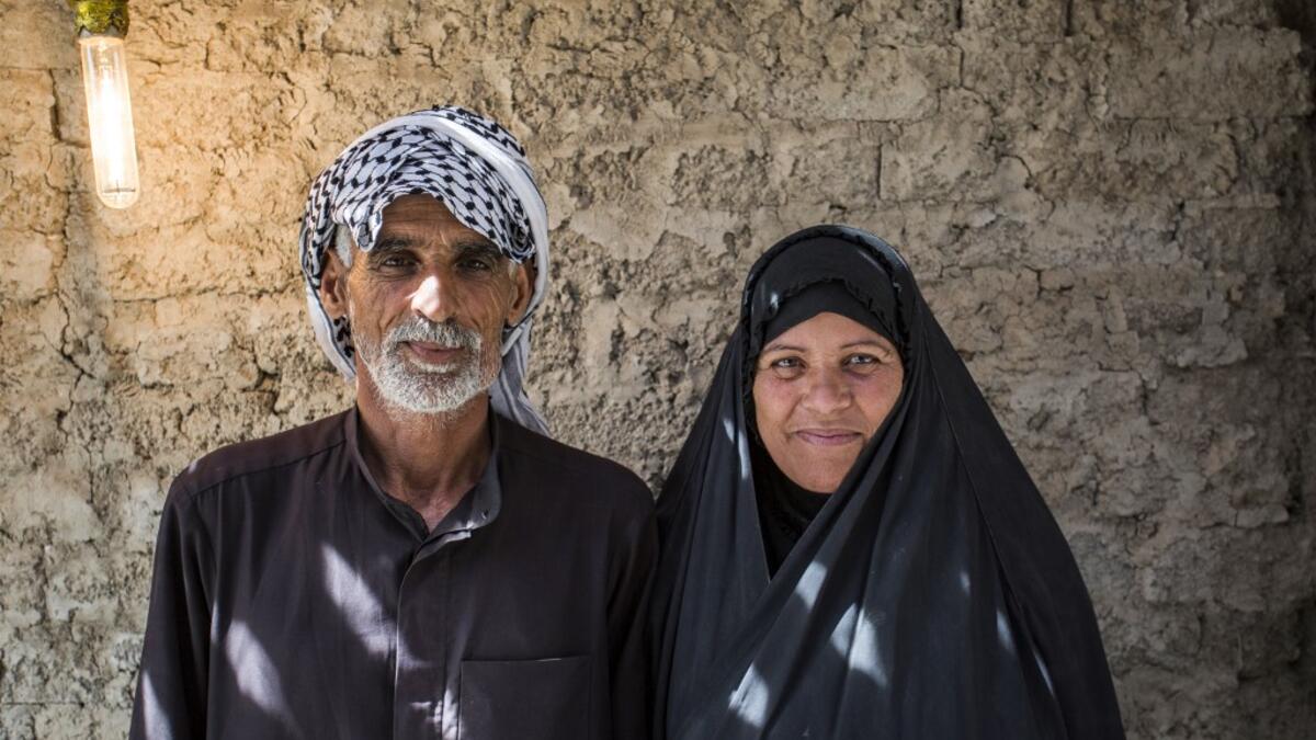 Abu Hayder, an Iraqi ecotourism guide, poses for a picture with his wife in the southern district of Chibayish in Dhi Qar province, about 120 kilometres northwest of the southern city of Basra, on March 29, 2019. Hussein FALEH / AFP