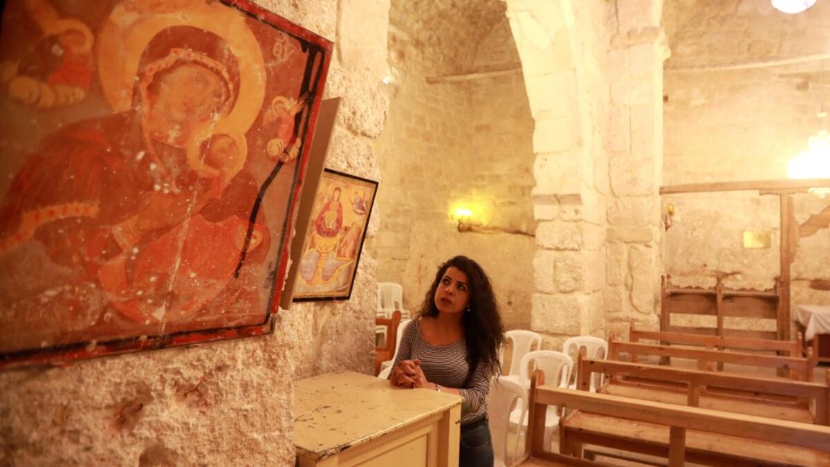 Rita Wahba recites hymns in Aramaic, at the Saint Sarkis monastery in the Syrian mountain village of Maalula, in the Damascus region on May 13, 2019. LOUAI BESHARA / AFP