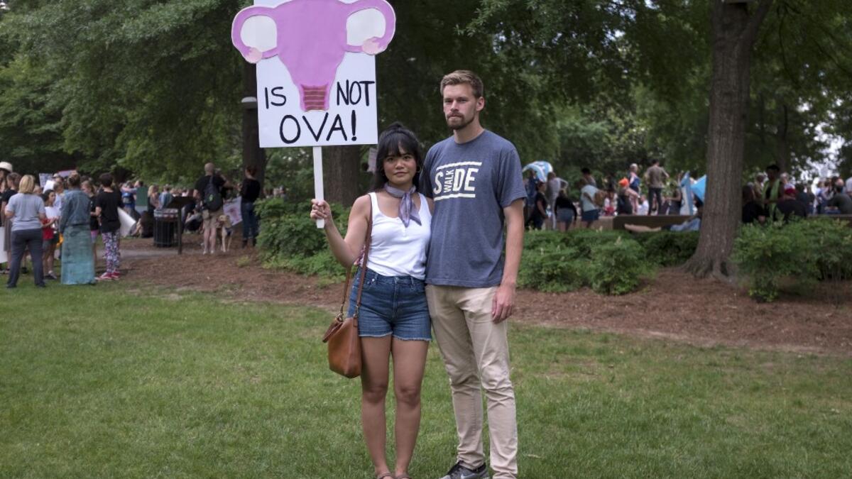 Cristina Castor (L) and Julian Kersh pose for a portrait in Ingram Park in Birmingham, Alabama, May 19, 2019 during the March for Reproductive Freedom. "If this goes all the way and flips Roe v Wade at that point it just seems like where is this going to stop," Kersh said. Seth HERALD / AFP