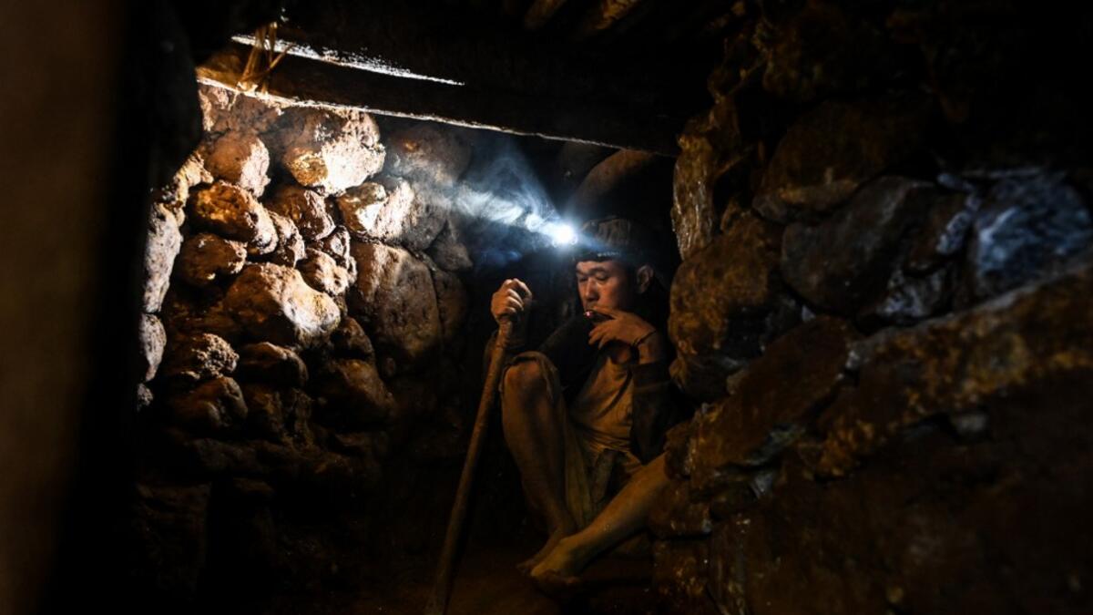 This photo taken on May 16, 2019 shows a miner working in a tunnel in a ruby mine in Mogok, north of Mandalay. Burrowing deep underground, thousands of informal miners risk their lives to find gleaming red gems as a law change spurs opportunity in Myanmar's "land of rubies". Ye Aung THU / AFP