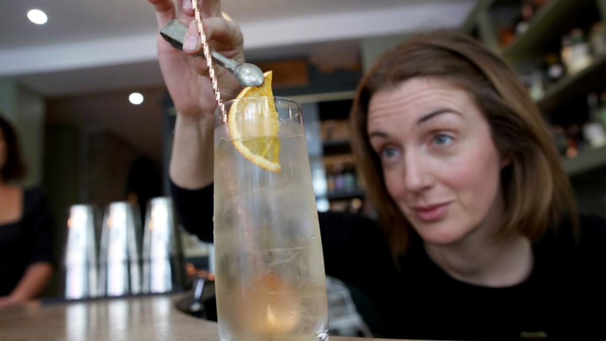 Head bartender Anna Walsh mixes a cocktail at the Virgin Mary pub, which opened recently selling non-alcoholic drinks and is known as the 'pub with no beer', in the city centre of Dublin on May 16, 2019. PAUL FAITH / AFP