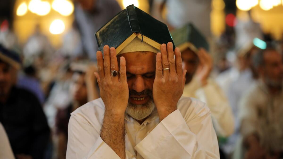 Shiite Muslim worshippers gather for the ritual prayer of Lailat al-Qadr, which marks the night in fasting month of Ramadan during which the Koran was first revealed to Prophet Mohammed in the seventh century, at the Imam Ali shrine in the central Iraqi holy city of Najaf on May 29, 2019. Haidar HAMDANI / AFP