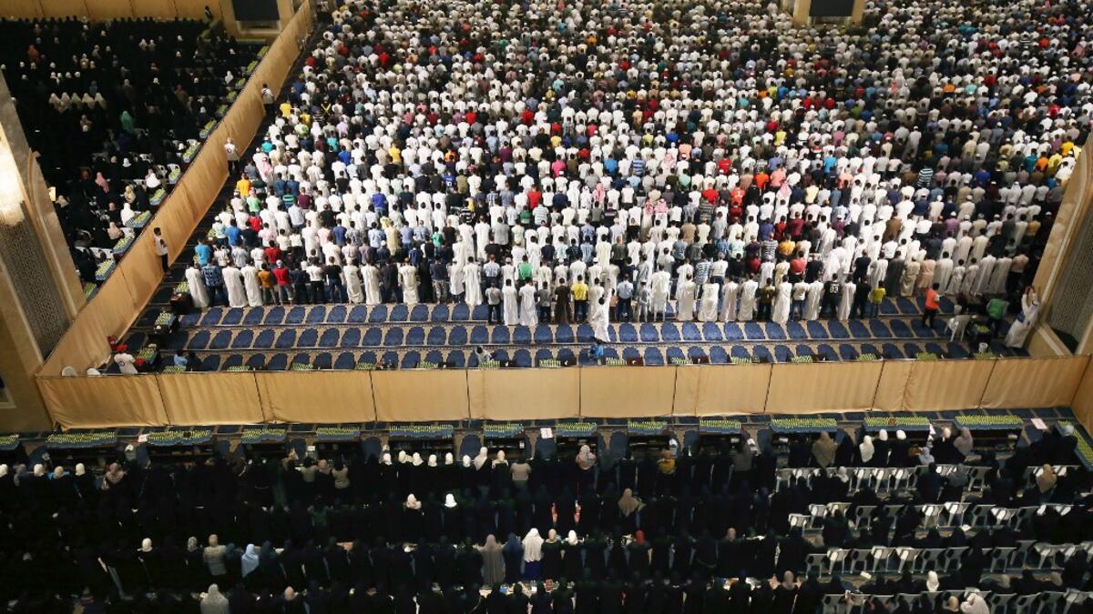 Muslim worshippers pray early on June 1, 2019 at Kuwait City's Grand Mosque on the occasion of Lailat al-Qadr, which marks the night in the fasting month of Ramadan during which the Koran was first revealed to Prophet Mohammed in the seventh century.  Yasser Al-Zayyat / AFP