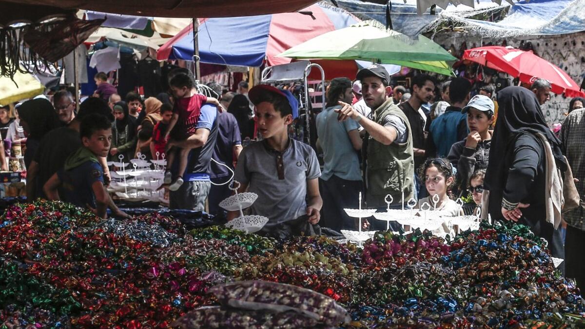 Palestinians shop at a market ahead of Eid al-Fitr holiday, celebrating the end of the holy Muslim fasting month of Ramadan, in Gaza City on June 2, 2019.  MAHMUD HAMS / AFP