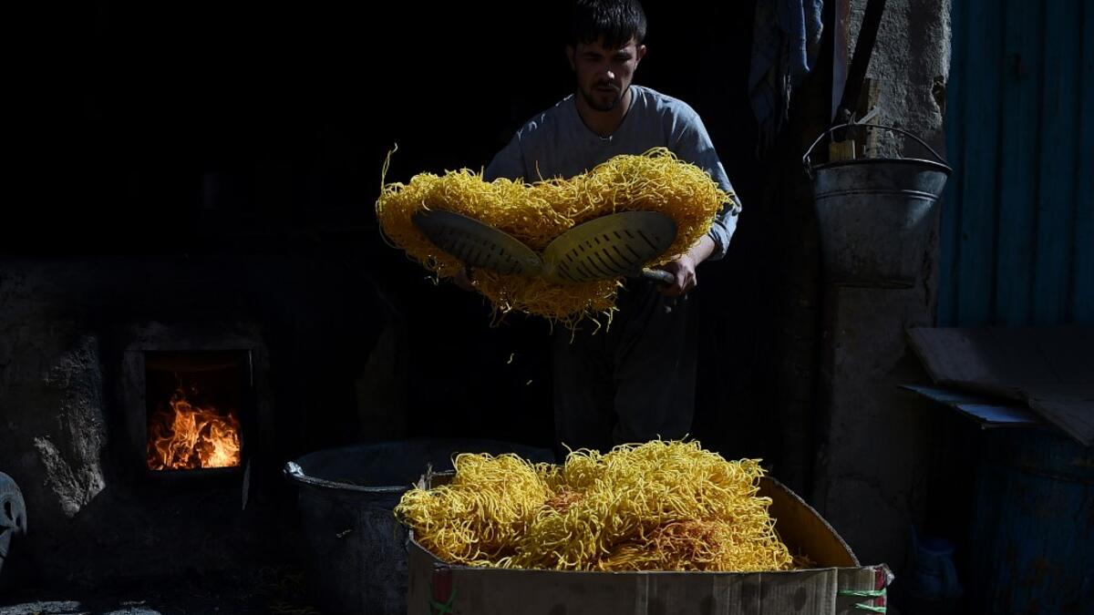 An Afghan worker prepares seemian, a local snack food made from flour and chilli, ahead of the Eid al-Fitr festival, which marks the end of Islamic holy month of Ramadan, at a traditional sweets factory in Kabul on June 2, 2019. WAKIL KOHSAR / AFP