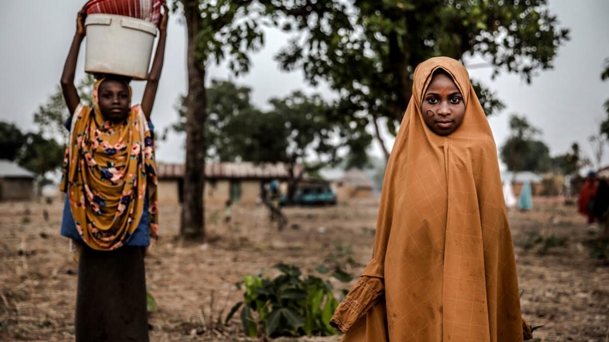 A Fulani girl stands poses for a portrait while attending to the market at Kachia Grazing Reserve, Kaduna State, Nigeria, on April 18, 2019. Luis TATO / AFP