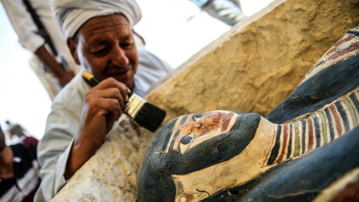 An Egyptian archaeological mission discovered a collection of stone, clay and wooden sarcophagi, of which some are still containing well preserved mummies, as well as a collection of wooden funerary masks and instruments used in cutting stones .  Mohamed el-Shahed / AFP