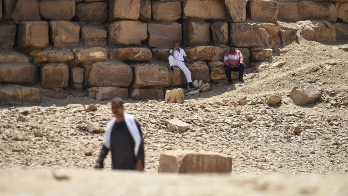 An Egyptian archaeological mission discovered a collection of stone, clay and wooden sarcophagi, of which some are still containing well preserved mummies, as well as a collection of wooden funerary masks and instruments used in cutting stones .  Mohamed el-Shahed / AFP
