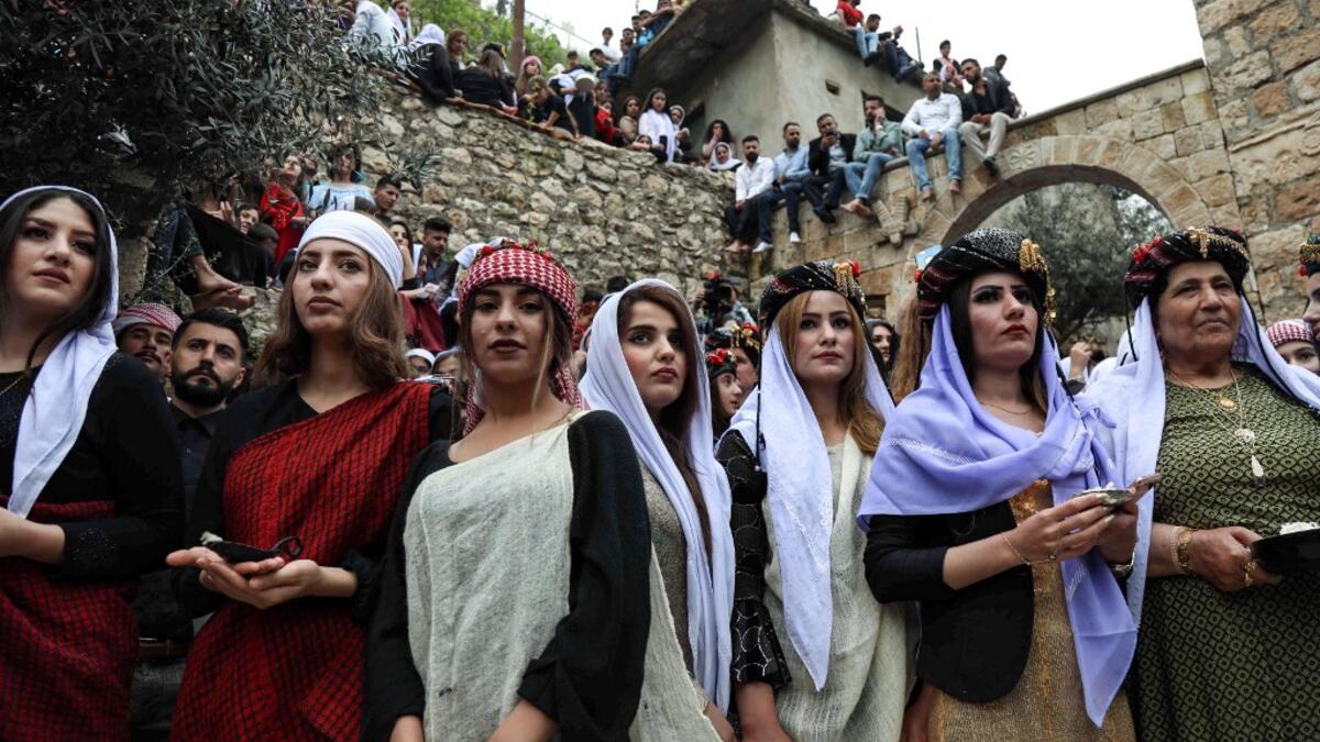 Iraqi Yazidi women light candles outside the Temple of Lalish, in a valley near the Kurdish city of Dohuk about 430 kilometres northwest of the capital Baghdad, on April 16, 2019, during a ceremony marking the Yazidi New Year. SAF