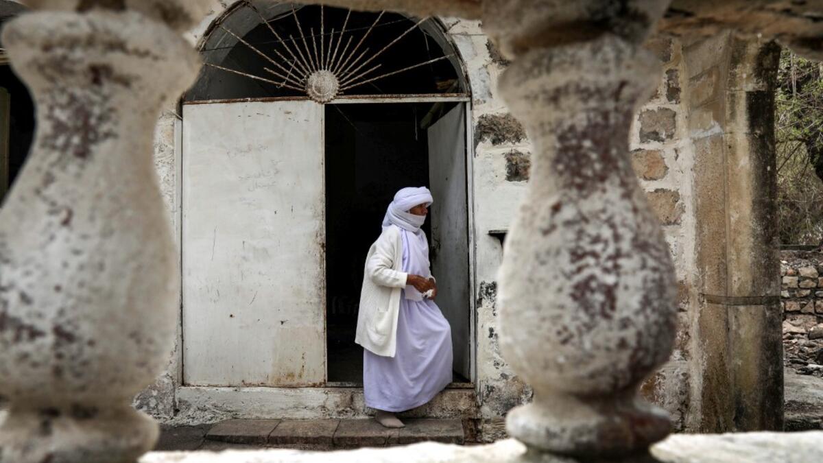 An Iraqi Yazidi visits the Temple of Lalish, in a valley near the Kurdish city of Dohuk about 430 kilometres northwest of the capital Baghdad, on April 16, 2019, during a ceremony marking the Yazidi New Year. Of the 550,000 Yazidis in Iraq before the Islamic State (IS) group invaded their region in 2014, around 100,000 have emigrated abroad and 360,000 remain internally displaced. Roughly 3,300 Yazidis have returned from IS captivity in the last five years, only 10 percent of them men. SAFIN HAMED / AFP