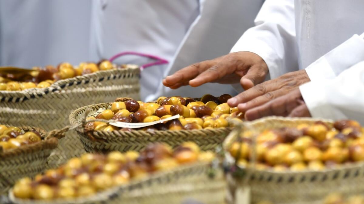 Emirati men inspect dates during the annual Liwa Date Festival in the western region of Liwa on July 17, 2019. Karim SAHIB / AFP