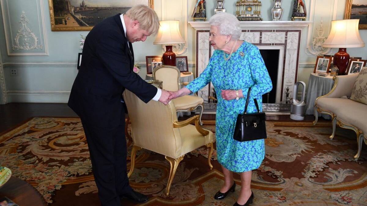 Britain's Queen Elizabeth II welcomes newly elected leader of the Conservative party, Boris Johnson during an audience in Buckingham Palace, London ON jULY 24, 2019, where she invited him to become Prime Minister and form a new government. Victoria Jones / POOL / AFP