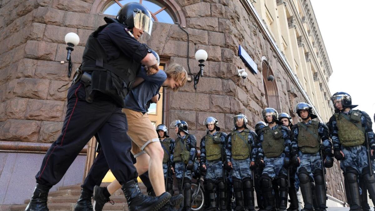 Riot police detain a protester during an unauthorised rally demanding independent and opposition candidates be allowed to run for office in local election in September, in downtown Moscow on July 27, 2019.  Kirill KUDRYAVTSEV / AFP