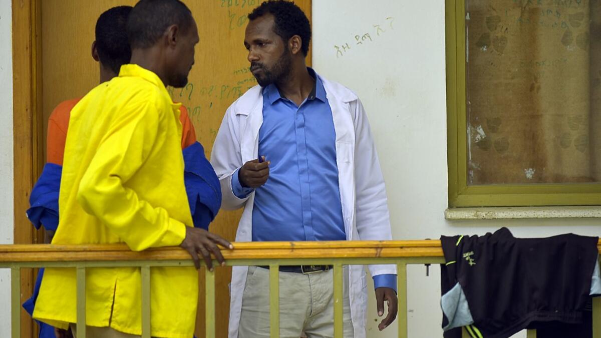 Welday Hagos (R), director of the Substance Rehabilitation Centre, the only facility in Ethiopia that offers long-term drug and alcohol addiction treatment, speaks with patients in Mekele on July 4, 2019. MICHAEL TEWELDE / AFP