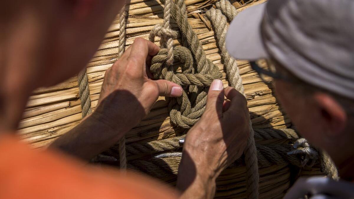 Members of the crew assemble the 14-meter long sailing reed boat Abora IV in the town of Beloslav, Bulgaria, on July 25, 2019. A team of two dozen researchers and volunteers from eight countries are preparing to set out in mid-August on a 1,300 kilometres (700 nautical mailes or 800 miles) journey to test the hypothesis that prehistoric trade routes traversed the high seas. NIKOLAY DOYCHINOV / AFP