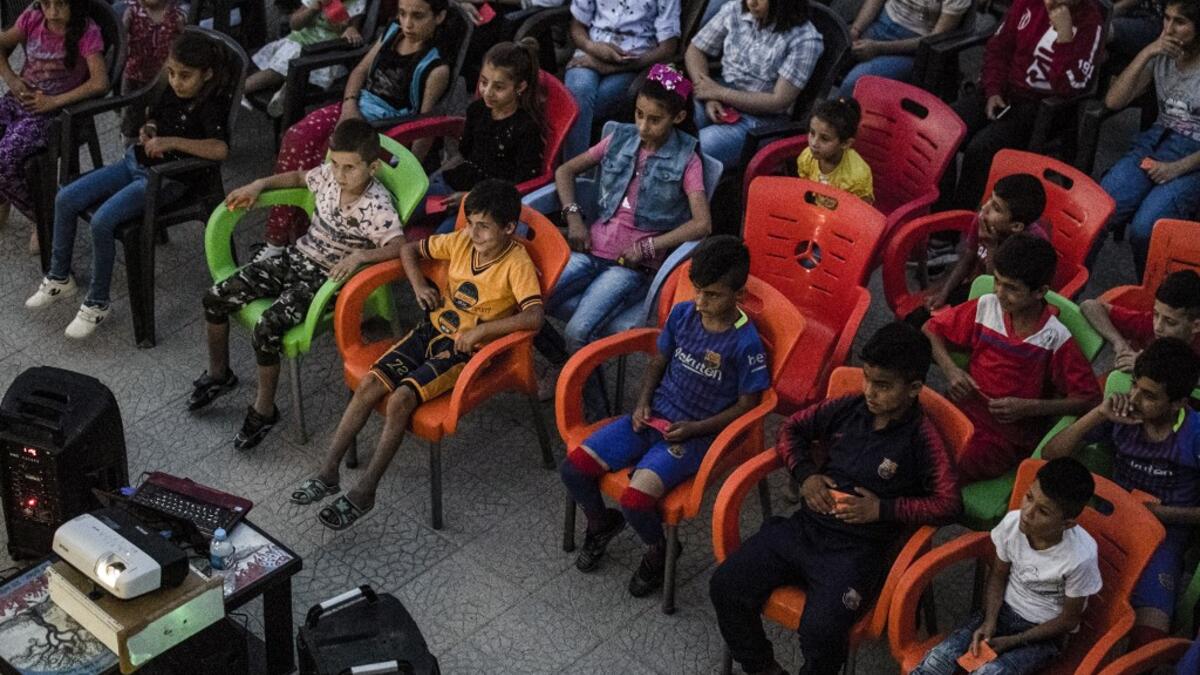 Hinde is screening films in remote villages using just a laptop, projector and a canvas screen. With some films dubbed into Kurdish and others subtitled, he and a team of volunteers want to spread their love of cinema across Rojava, the Kurdish name of the semi-autonomous northeast of war-torn Syria. DELIL SOULEIMAN / AFP