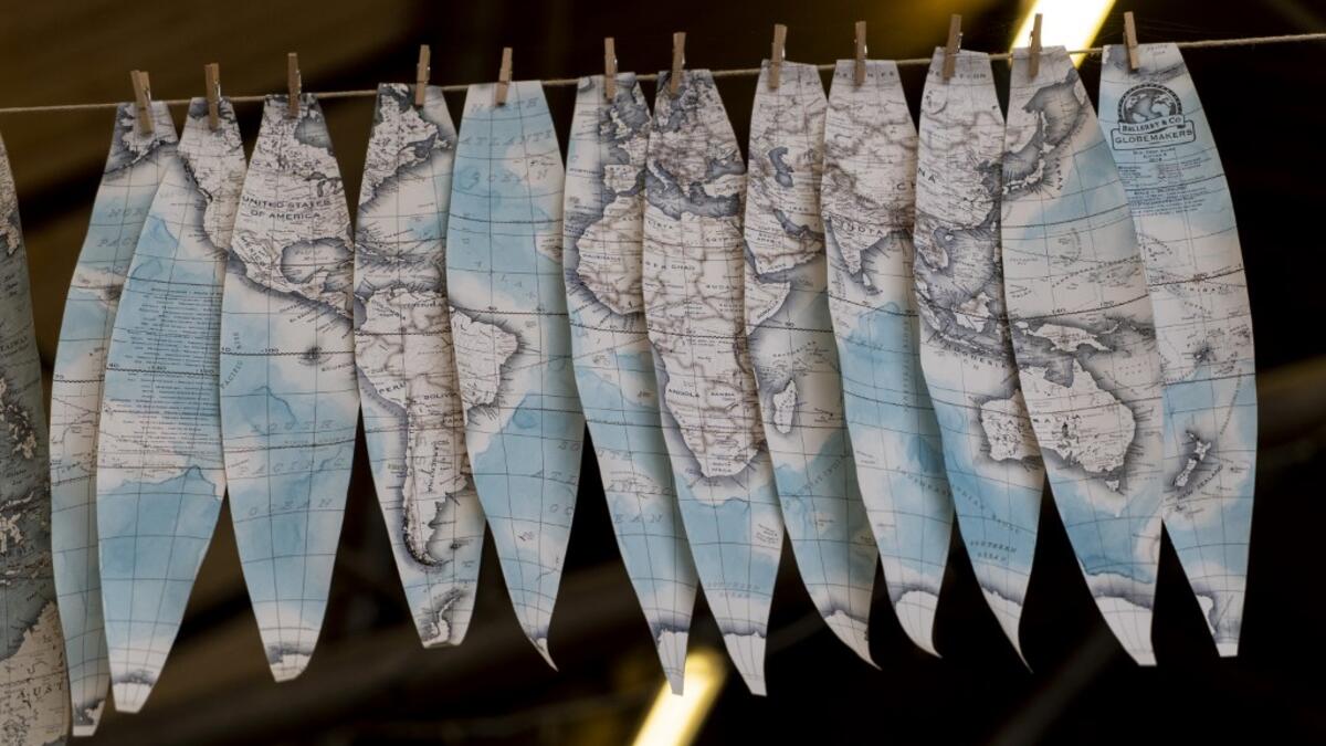 Hand-painted cartography on oval shaped strips called "gores" dry at the Bellerby and Co Globemakers' workshop and headquarters in Stoke Newington in north London, on July 19, 2019. Niklas HALLE'N / AFP