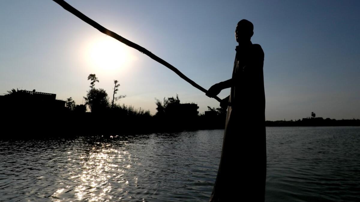 An Egyptian Fisherman sails in the waters of the Pharaonic Sea in the village of Kafr Fisha, province of Monufia, on August 13, 2019.Mohamed el-Shahed / AFP