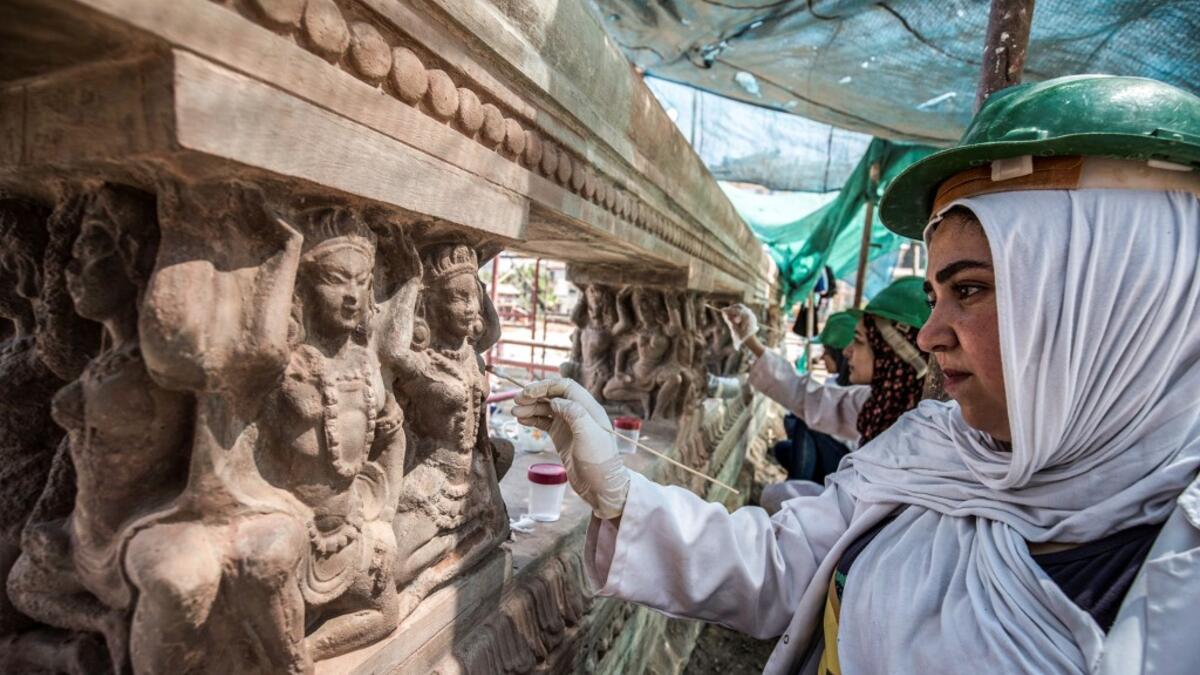 Archaeologists work on restoring relief sculptures at the historic "Le Palais Hindou" (also known as the "Baron Empain Palace") built by in the early 20th century by Belgian industrialist Edouard Louis Joseph, Baron Empain, in the classical Khmer architectural style of Cambodia's Angkor Wat, in the Egyptian capital Cairo's northeastern Heliopolis district on August 18, 2019.  Khaled DESOUKI / AFP
