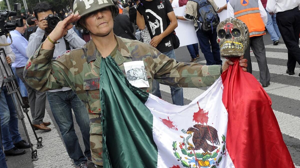In this file photo taken on September 26, 2016 Mexican activist Julia Klug takes part in a protest in Mexico City, commemorating the second anniversary of the disappearance of the Ayotzinapa students. Pedro Pardo / AFP