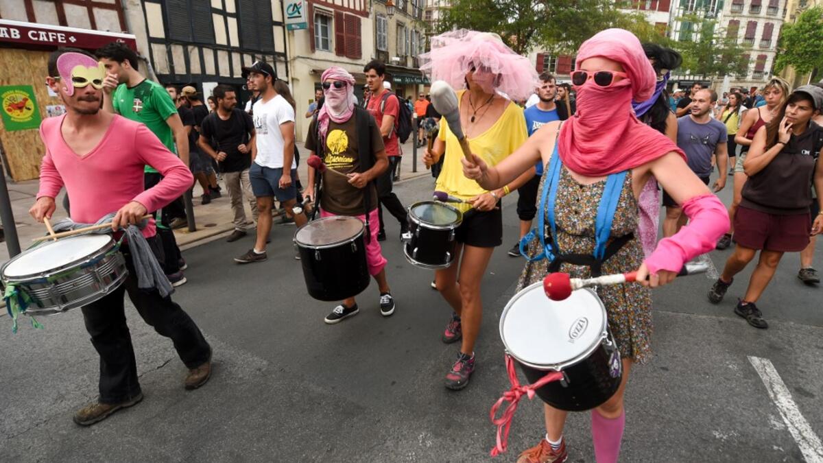 People play drums during a demonstration in Bayonne, south-west France on August 24, 2019, on the sidelines of the annual G7 Summit attended by the leaders of the world's seven richest democracies. GAIZKA IROZ / AFP