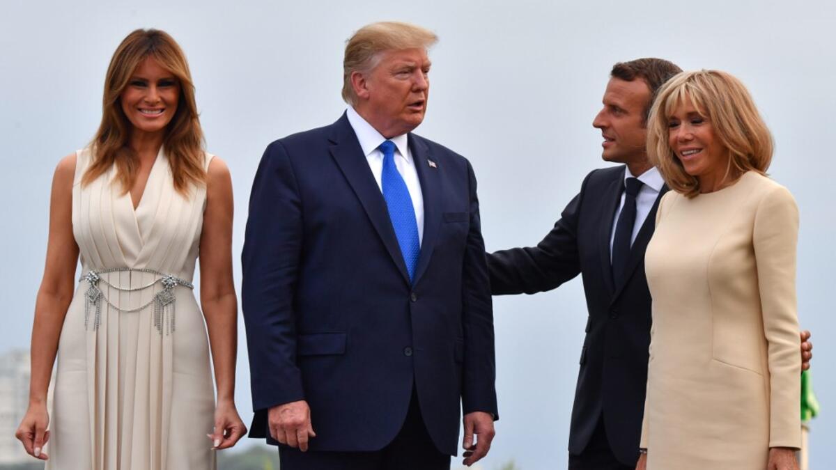French President Emmanuel Macron (2ndR) and his wife Brigitte Macron (R) pose with US President Donald Trump (2ndL) and US First Lady Melania Trump at the Biarritz lighthouse, southwestern France, ahead of a working dinner on August 24, 2019. Nicholas Kamm / AFP