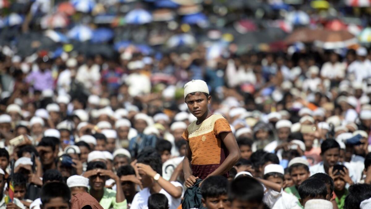 Rohingya refugees attend a ceremony organised to remember the second anniversary of a military crackdown that prompted a massive exodus of people from Myanmar to Bangladesh, at the Kutupalong refugee camp in Ukhia on August 25, 2019. MUNIR UZ ZAMAN / AFP