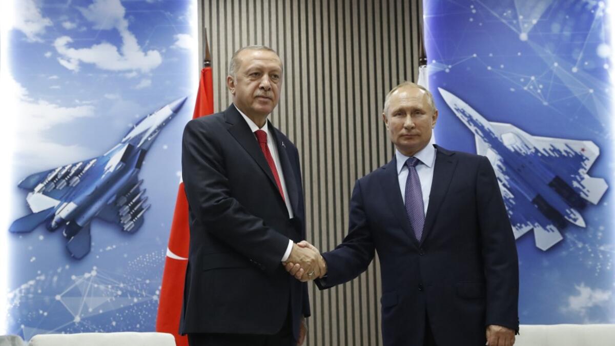 Turkish President Recep Tayyip Erdogan (L) shakes hands with his host Russian President Vladimir Putin as they visit the MAKS-2019 International Aviation and Space Salon opening day in Zhukovsky outside of Moscow on August 27, 2019.  Maxim SHIPENKOV / POOL / AFP