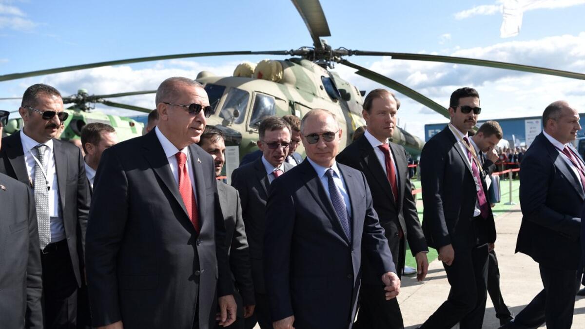 Russian President Vladimir Putin (C) and his Turkish counterpart Recep Tayyip Erdogan (2L) walk as they visit the MAKS 2019 International Aviation and Space Salon opening day in Zhukovsky outside of Moscow on August 27, 2019.  Alexey NIKOLSKY / SPUTNIK / AFP