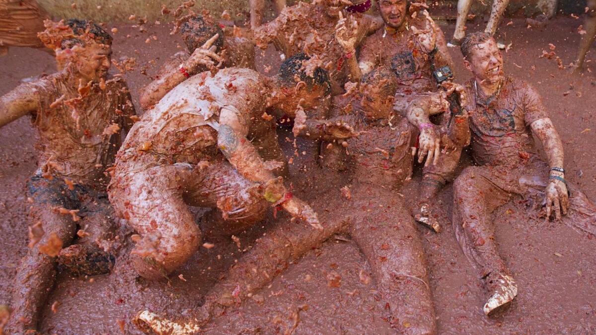 Revellers covered in tomato pulp take part in the annual "Tomatina" festival in the eastern town of Bunol, on August 28, 2019. JAIME REINA / AFP