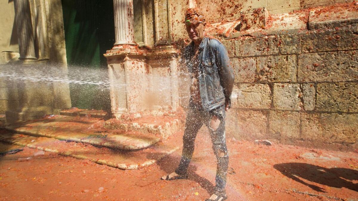 The iconic fiesta, which is billed at "the world's biggest food fight" has become a major draw for foreigners, in particular from Britain, Japan and the United States. JAIME REINA / AFP