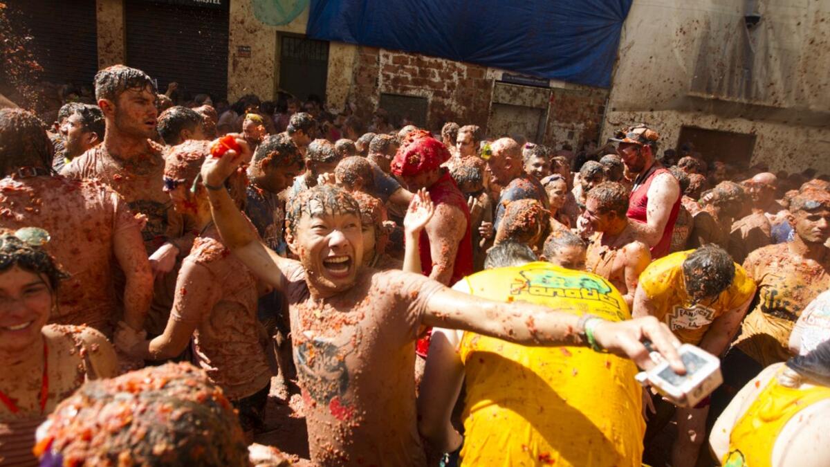 Revellers covered in tomato pulp take part in the annual "Tomatina" festival in the eastern town of Bunol, on August 28, 2019. JAIME REINA / AFP