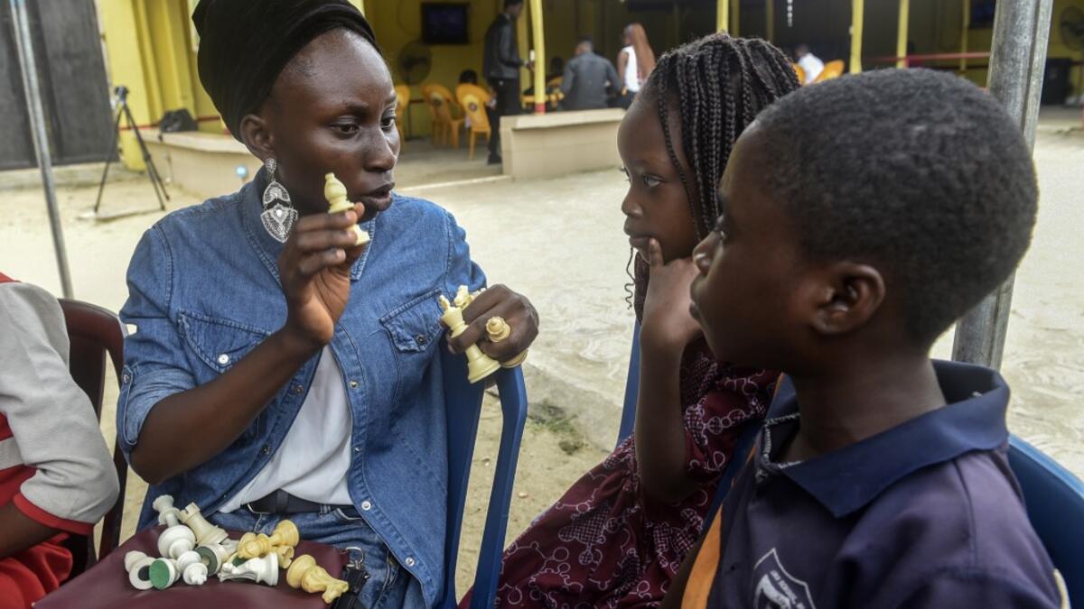 Chess teacher Omiwale Mistura (L) conducts a tutorial during a chess class at Ogolonto in Ikorodu district of Lagos on August 17, 2019. In front of chess boards in Lagos, children are busy, concentrating. PIUS UTOMI EKPEI / AFP