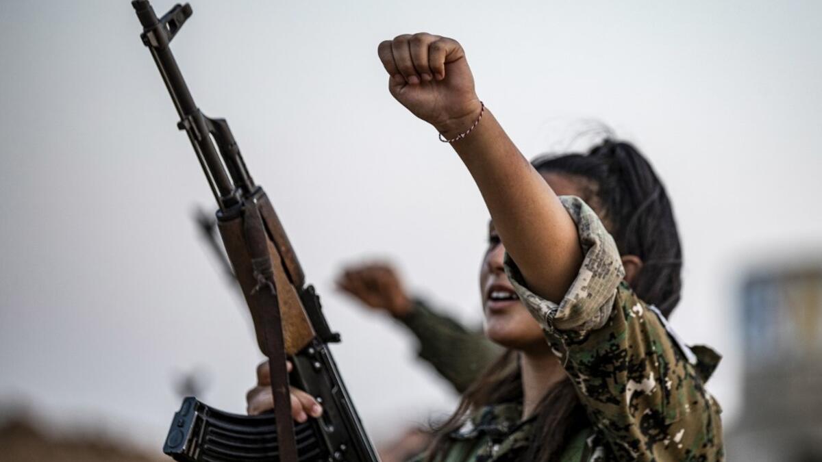 A member of the Bethnahrin Women Protection Forces (HSNB), an all-female Syriac-Assyrian paramilitary group under the umbrella of the Syrian Democratic Forces (SDF), chants slogans as during a commemoration of the fourth anniversary of their creation, in the countryside of the town of Tall Tamr in the northwestern Syrian province of Hasakah, on August 30, 2019.  Delil SOULEIMAN / AFP