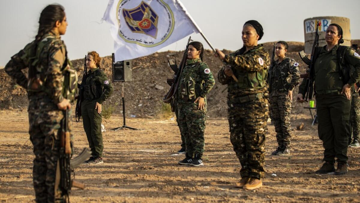 Members of the Bethnahrin Women Protection Forces (HSNB), an all-female Syriac-Assyrian paramilitary group under the umbrella of the Syrian Democratic Forces (SDF), line-up as they commemorate the fourth anniversary of their creation, in the countryside of the town of Tall Tamr in the northwestern Syrian province of Hasakah, on August 30, 2019.  Delil SOULEIMAN / AFP